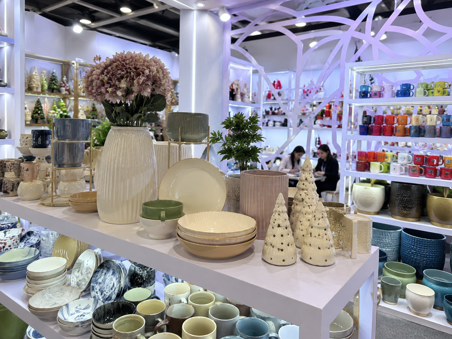 Well-arranged Youli ceramic booth product display with tableware, mugs, vases, planters, and seasonal decor