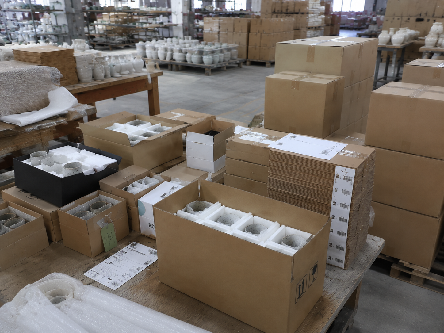 Ceramic products arranged with custom boxes, labels, and export packing materials