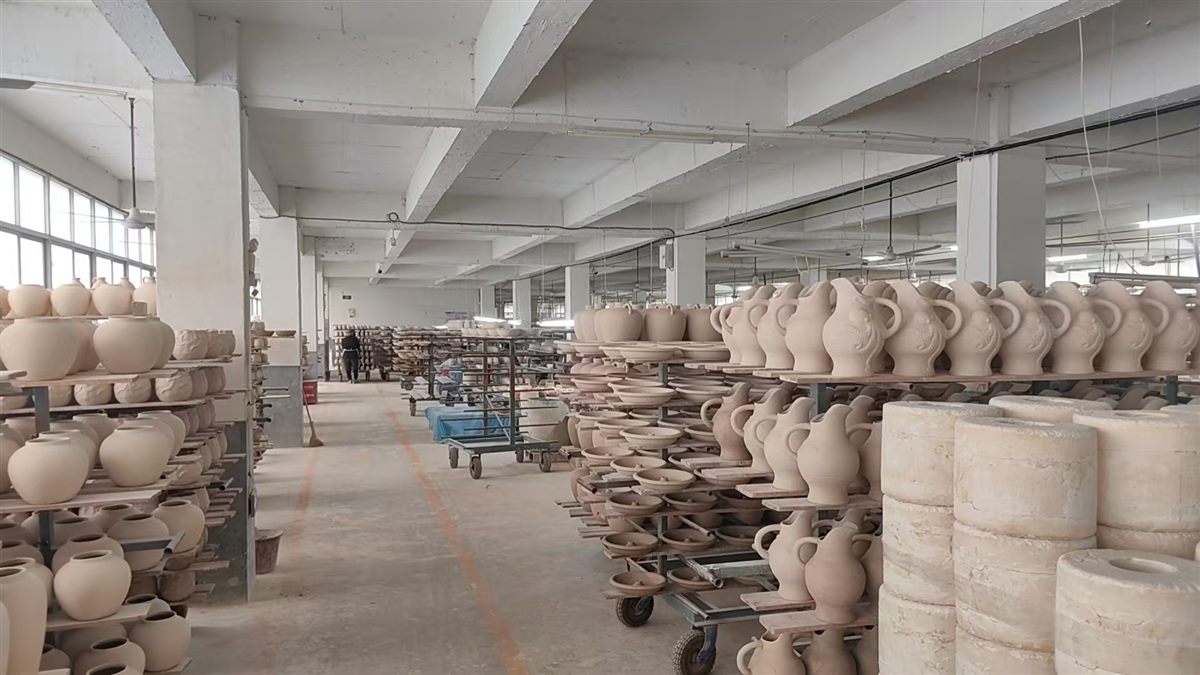 Rows of ceramic vases and planters prepared in the factory workshop